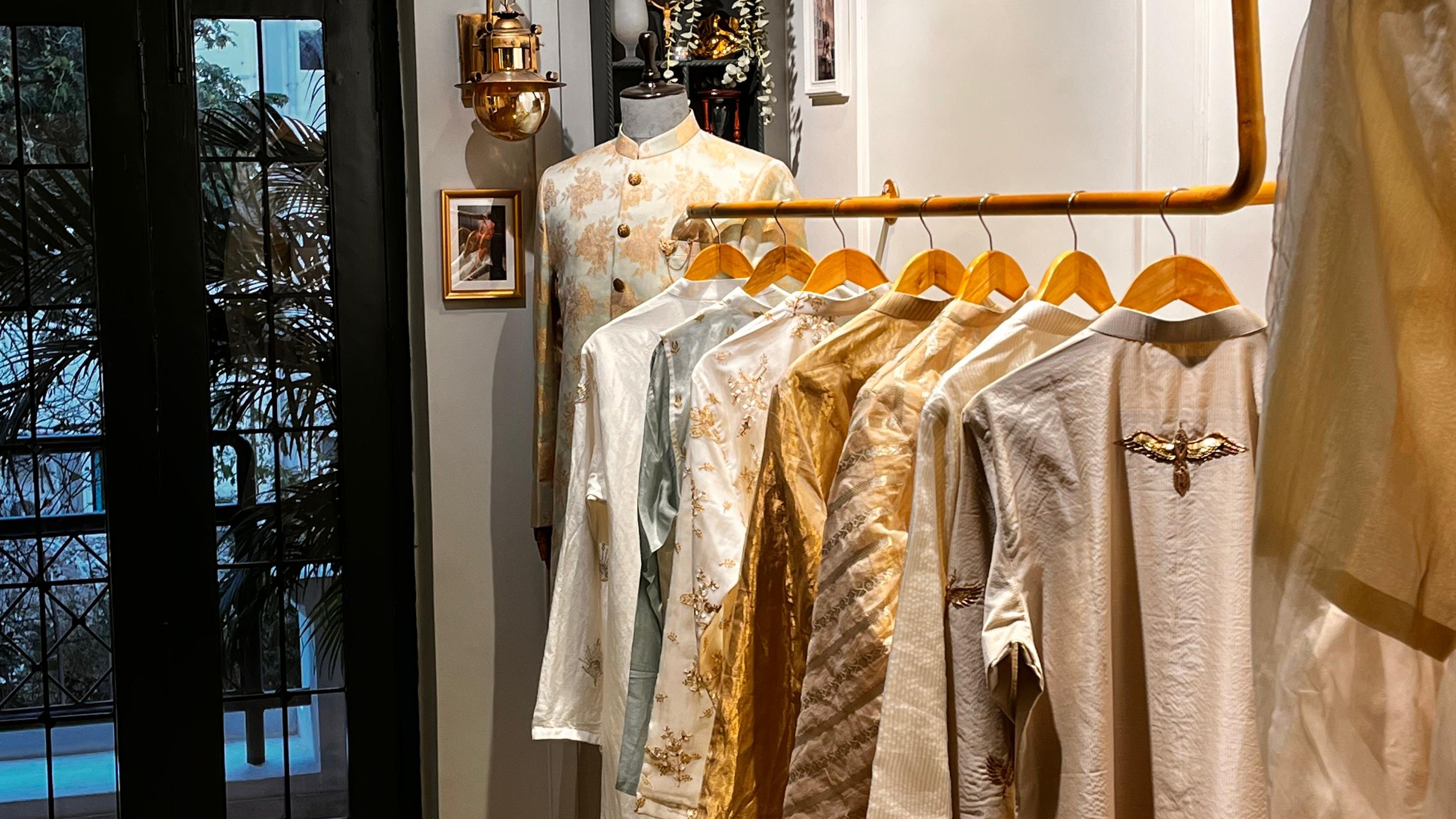 Clothing rack with various garments in a room setting